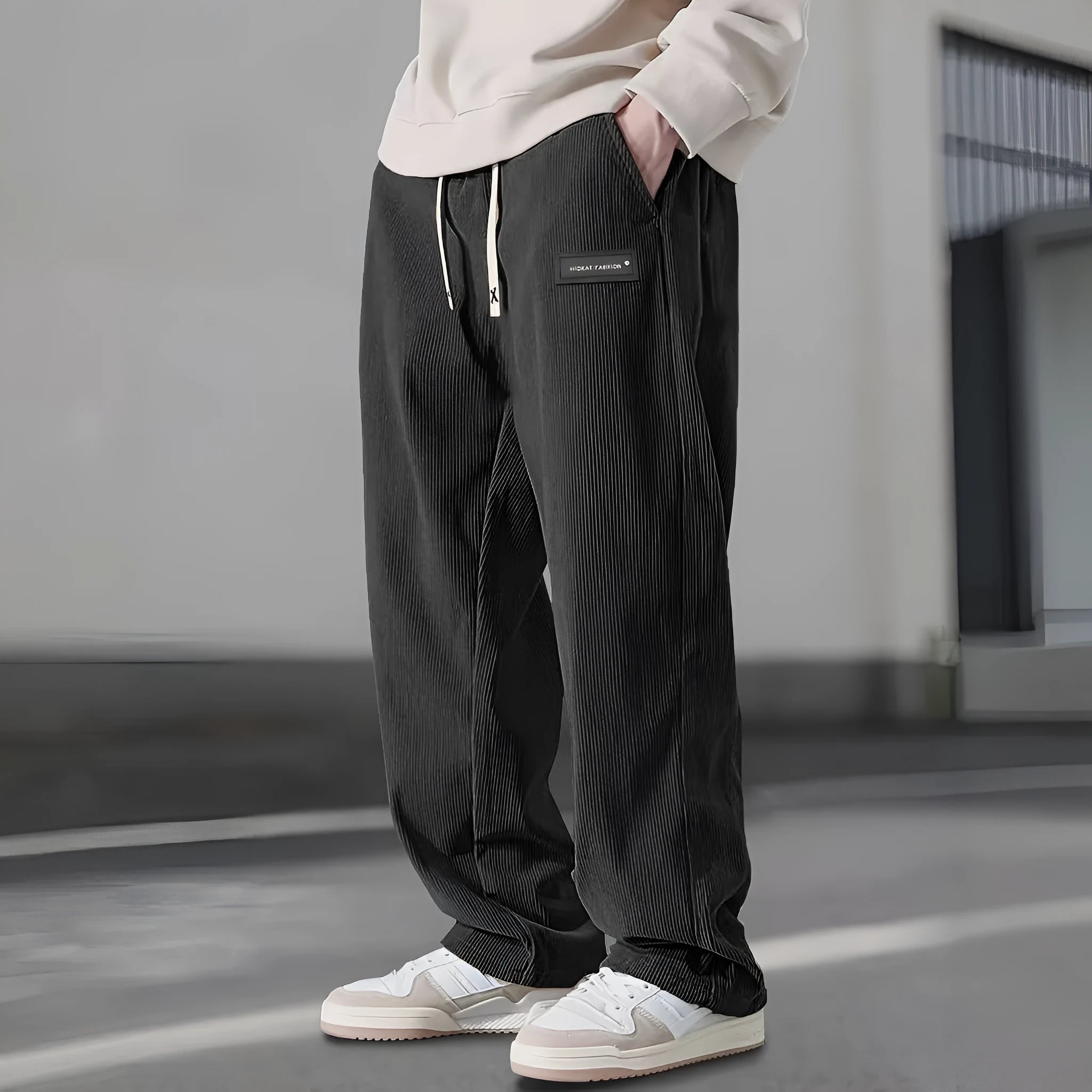 Men's straight leg corduroy trousers in khaki, drawstring waist, mid rise, polyester fabric, side view on model