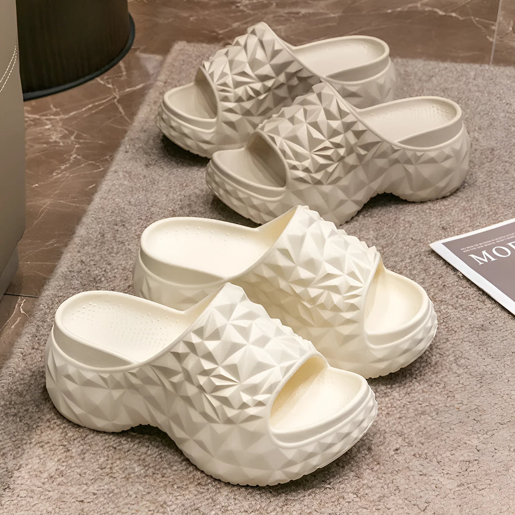 A pair of khaki high heel flip flop slippers made from injection moulded EVA with a thick sole.