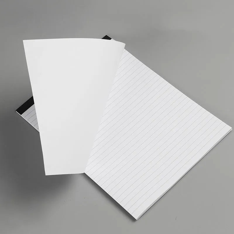 A4 size tearable grid notebook with paper cover, open to show ivory white pages.