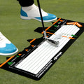 Black neoprene golf swing stance correction training pad on grass