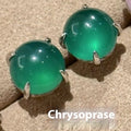 Round egg surface chalcedony stud earrings with four claw settings in emerald green, milk white, or pink purple.