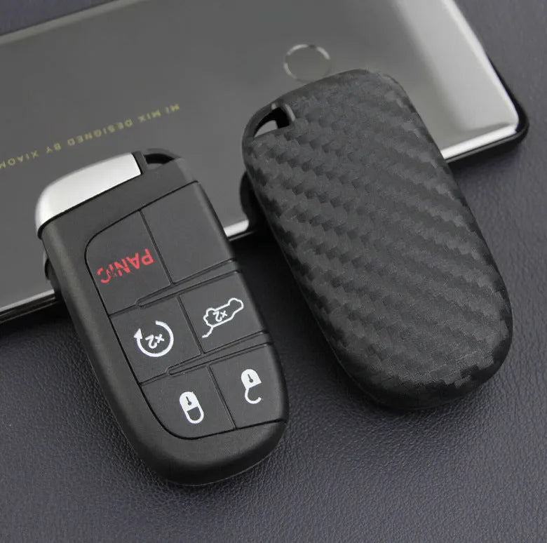 Carbon fibre pattern silicone protective case for a Dodge, Chrysler, or Fiat car key remote with a large head buckle.