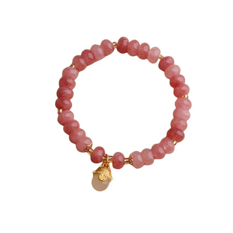 Women's retro strawberry quartz bracelet with lucky cat charm on wrist