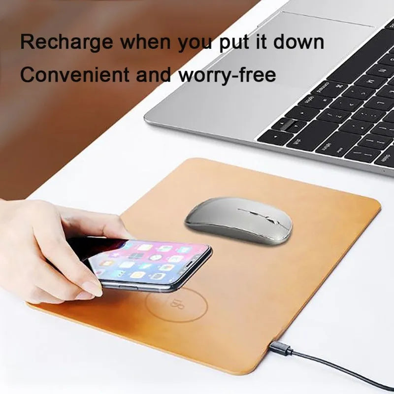 Brown leather-textured wireless charging mouse pad with a Micro USB cable on a wooden desk.