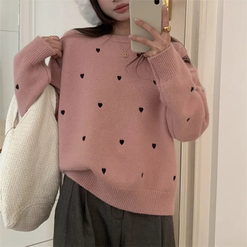 Women's loose cream pullover sweater with embroidered red love pattern on the front.