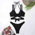Solid colour strap bikini swimsuit for women on a mannequin, showing the brief cut and sleeveless design.