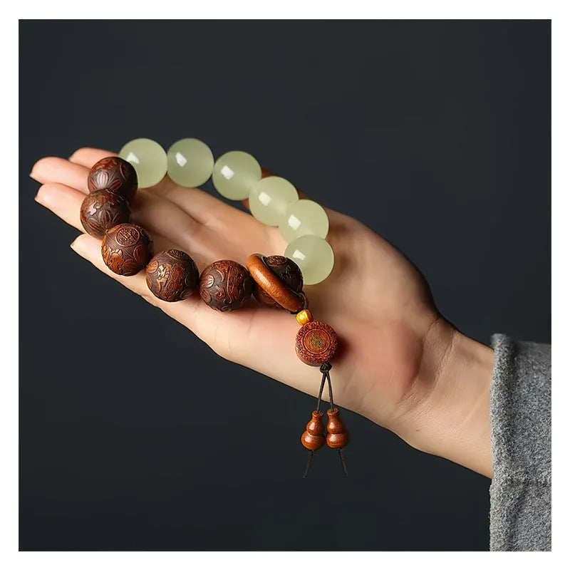 Rosewood flexible bracelet with fu character carving showing 12 wooden pieces connected by flexible cord