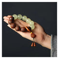 Rosewood flexible bracelet with fu character carving showing 12 wooden pieces connected by flexible cord
