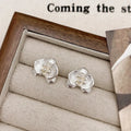 Women's retro flower earrings in copper with gold or silver electroplated finish showing petal detailing