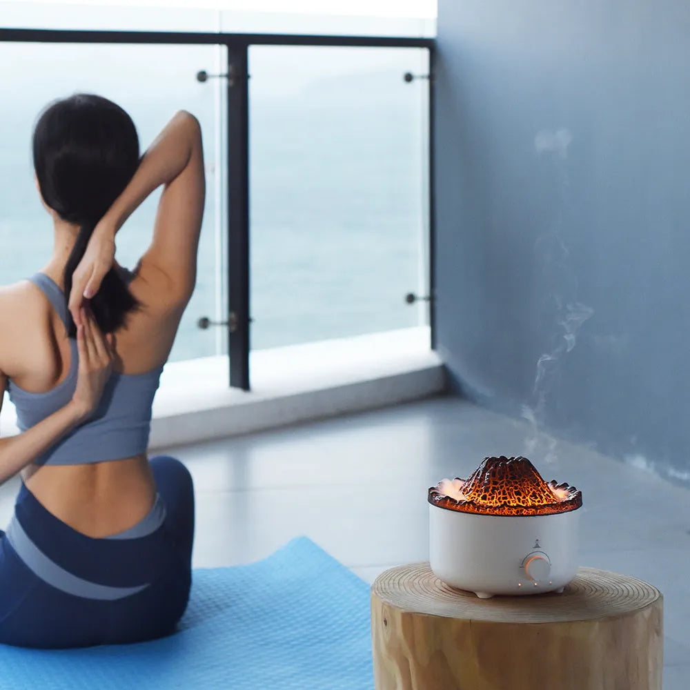 White simulated flame volcano humidifier with remote control showing orange and blue lighting effects