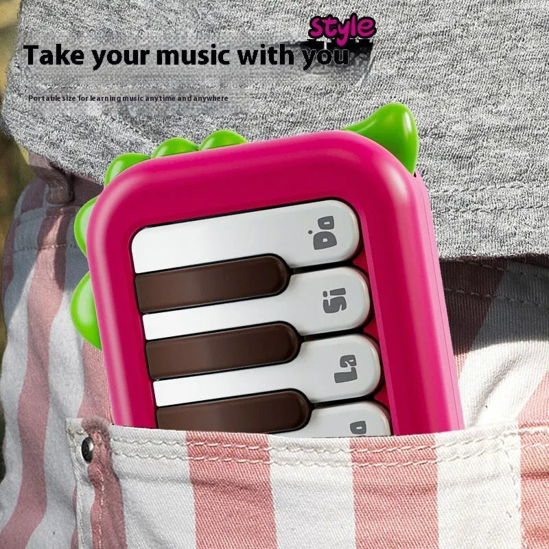 Pocket electronic keyboard little piano pattern toy for children in green and pink plastic.