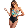 Women's black one-piece swimsuit with a printed green and yellow patchwork leaf pattern.