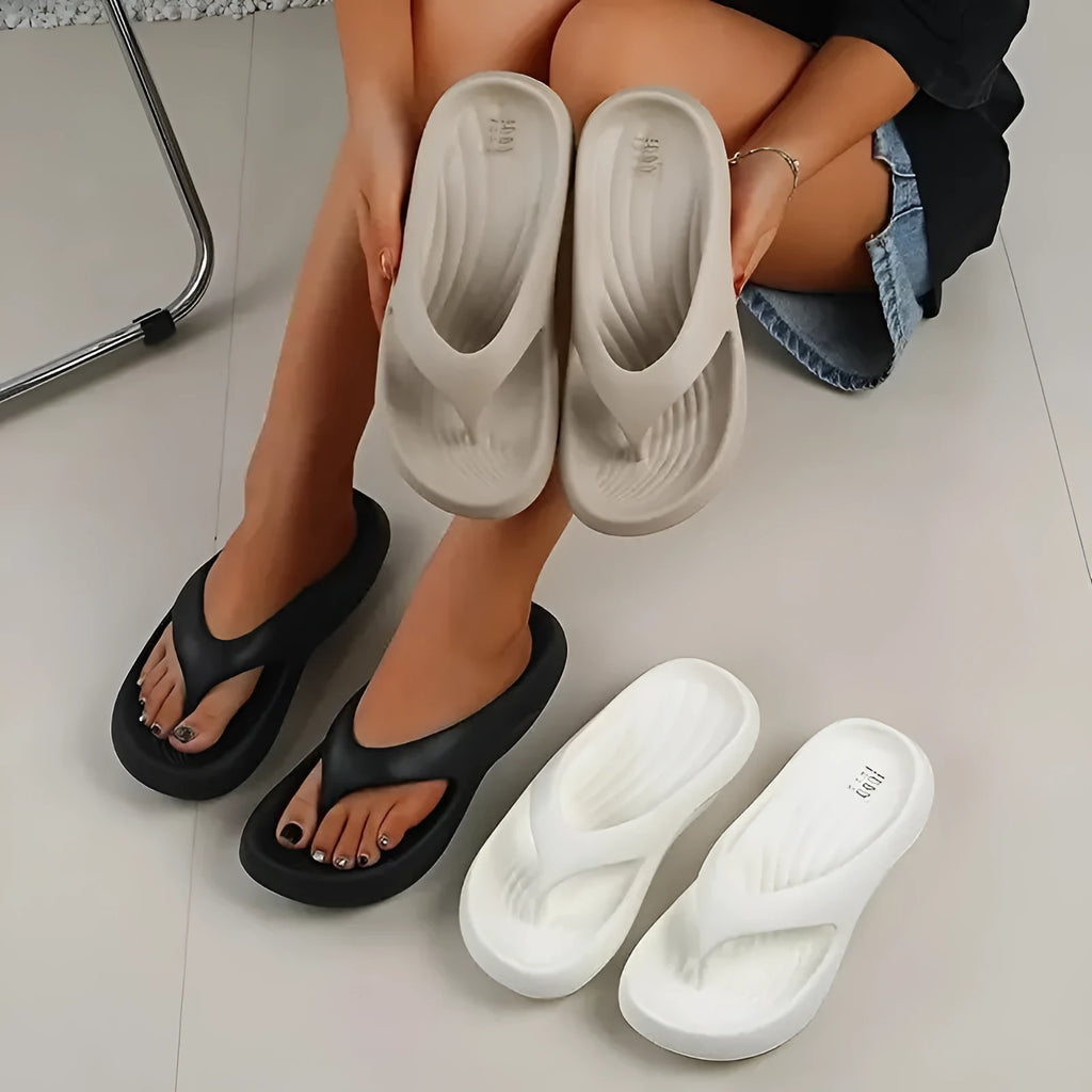 Women's black thick-soled EVA flip-flops with a non-slip sole pattern