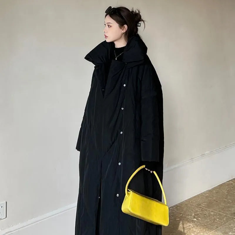 Women's large size mid-length loose fit winter coat with front zipper in black on a model