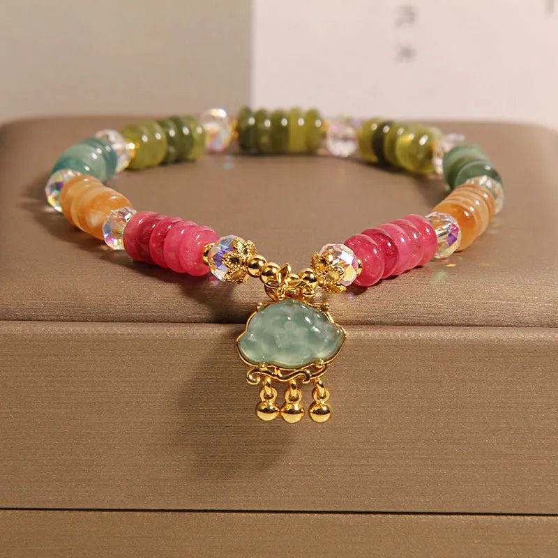 Colorful Tourmaline Jade Xiangyun crystal bracelet with alloy inlay and stone accents on display