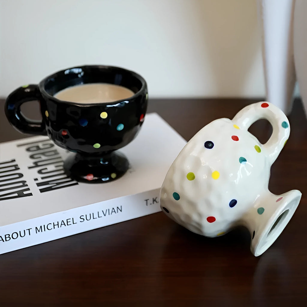 Hand-pinched irregular shaped solid colour ceramic mug on a table.