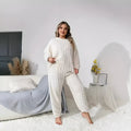 Women's creamy white plush polyester two-piece set with crew neck top and full-length trousers