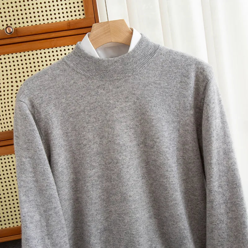 A man wearing a half-collar loose-fit wool sweater in a light business style, shown in a neutral colour.