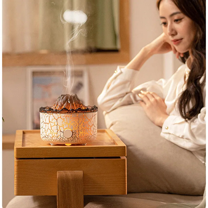 Volcano-shaped humidifier with LED flame effect emitting mist rings for atmospheric room enhancement