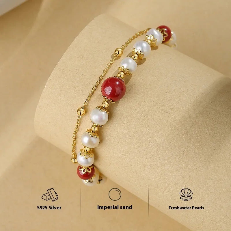 Sterling silver double-layer bracelet with white freshwater pearls and red cinnabar bean charms