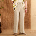 Navy blue linen straight-leg trousers with a high elasticated waistband laid flat.
