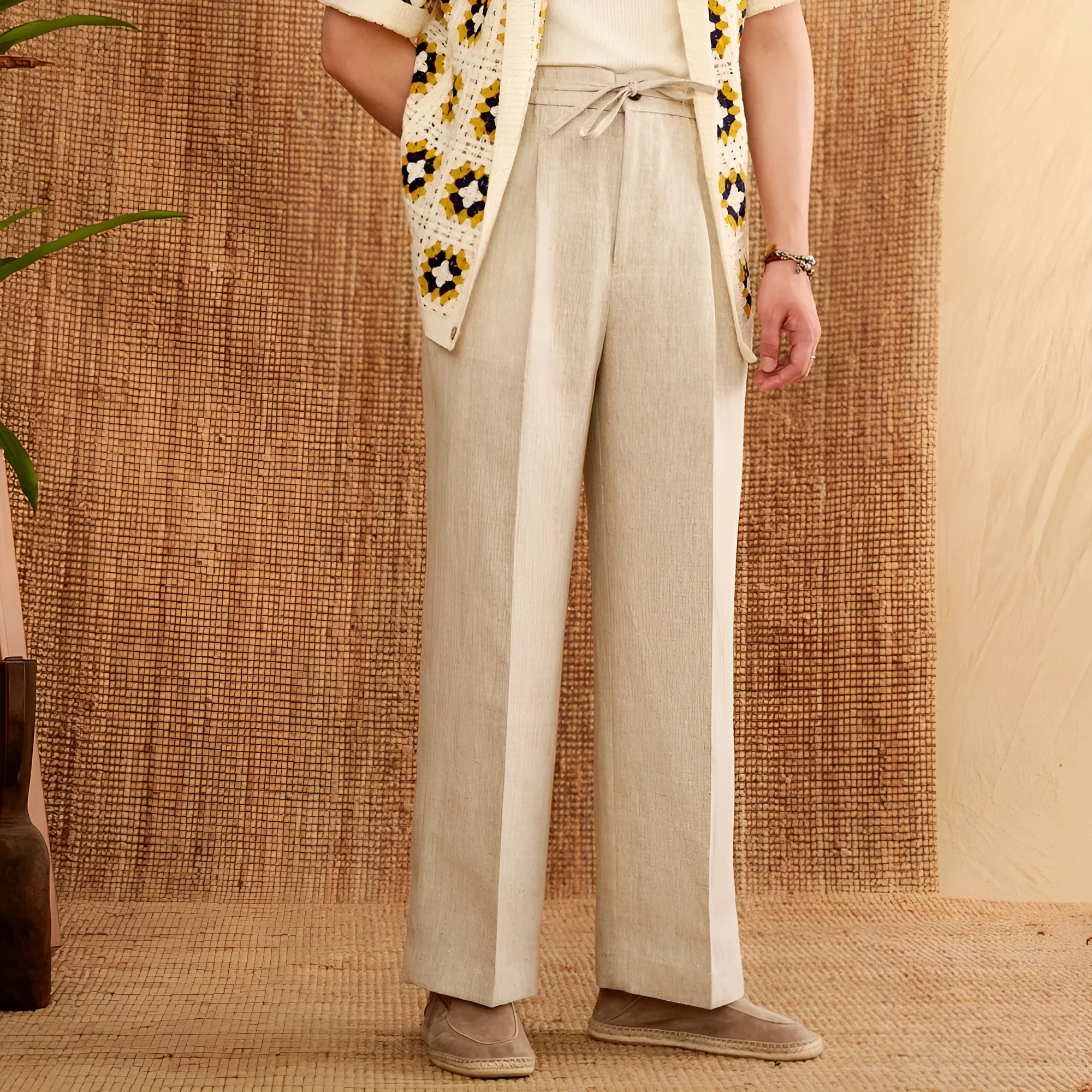 Navy blue linen straight-leg trousers with a high elasticated waistband laid flat.