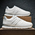 Men's black leather casual sports shoes with carved wing pattern detail and a high heel.
