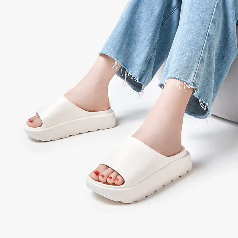 Women's beige fish mouth slippers with a thick 5.5cm EVA sole on a tiled floor.