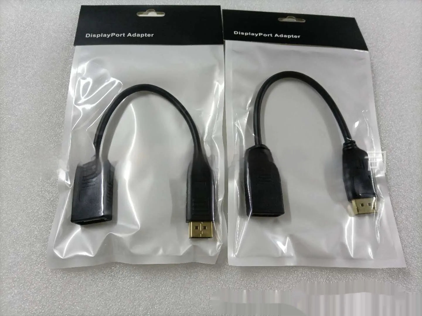 Black Display Port male to female extension cable approximately 10cm long