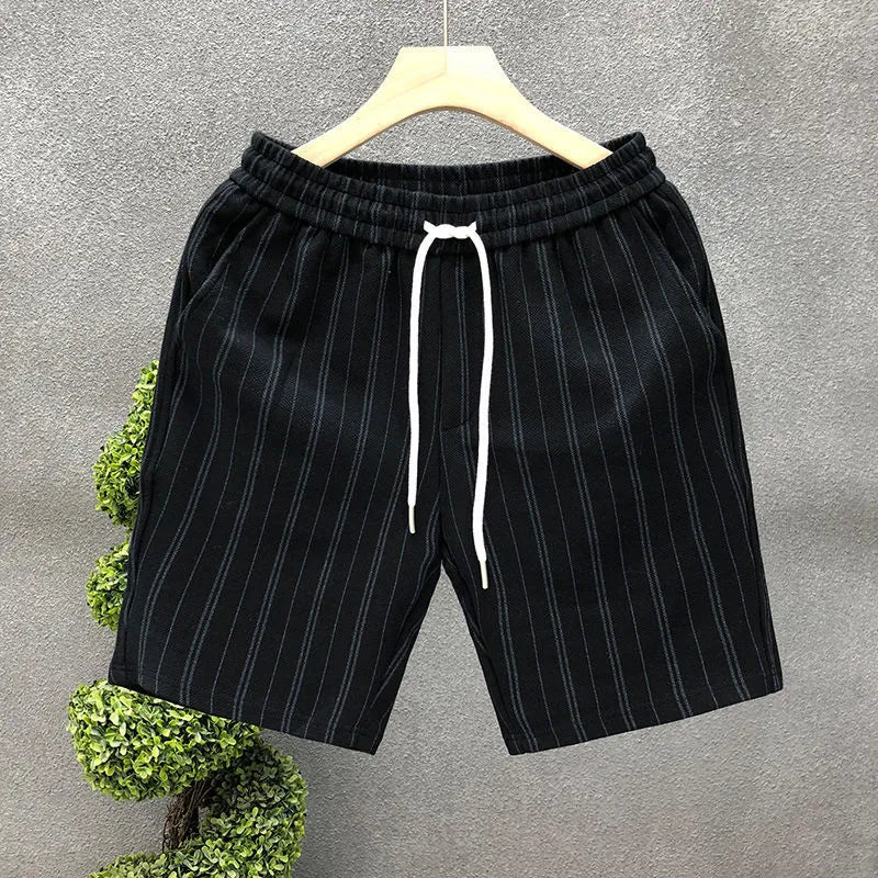 Men's black and white striped fleece-lined casual shorts with an elasticated waistband.