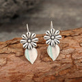 Silver alloy clip-on earrings with artificial gemstone inlays, vintage floral style, sold as a pair