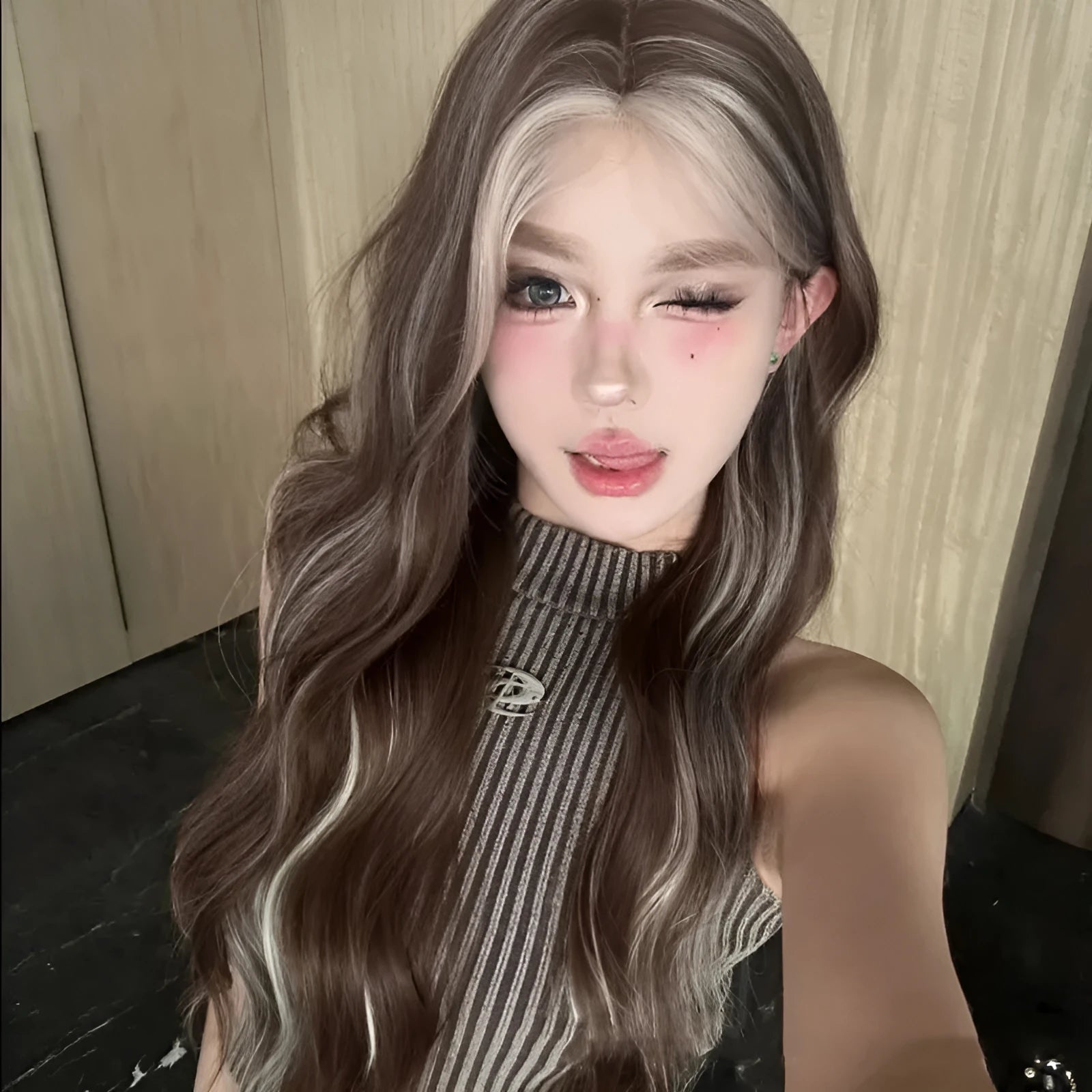 Gray golden highlight long curly lace wig with hair net on display