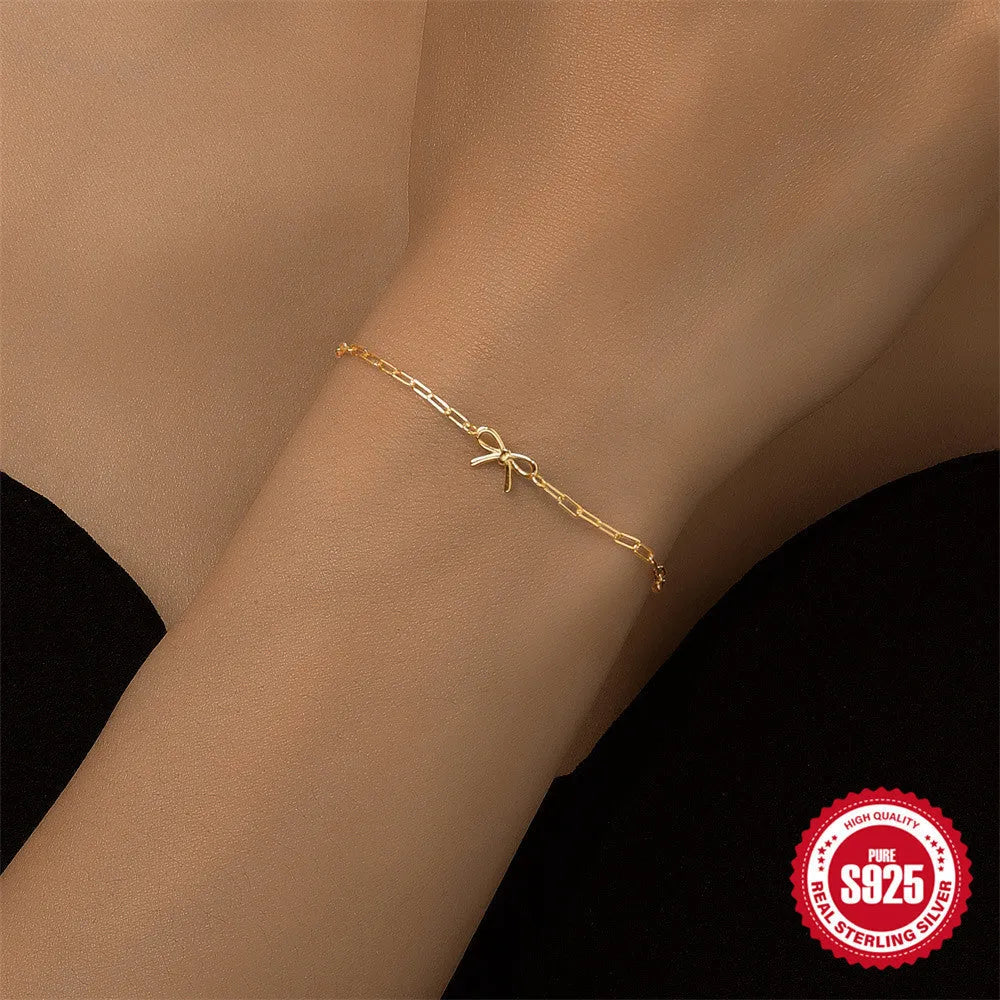S925 sterling silver bracelet with heart charm and clip chain clasp in gold tone