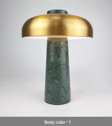 Modern alloy desk lamp with a rechargeable battery and touch-sensitive dimming switch on a wooden desk