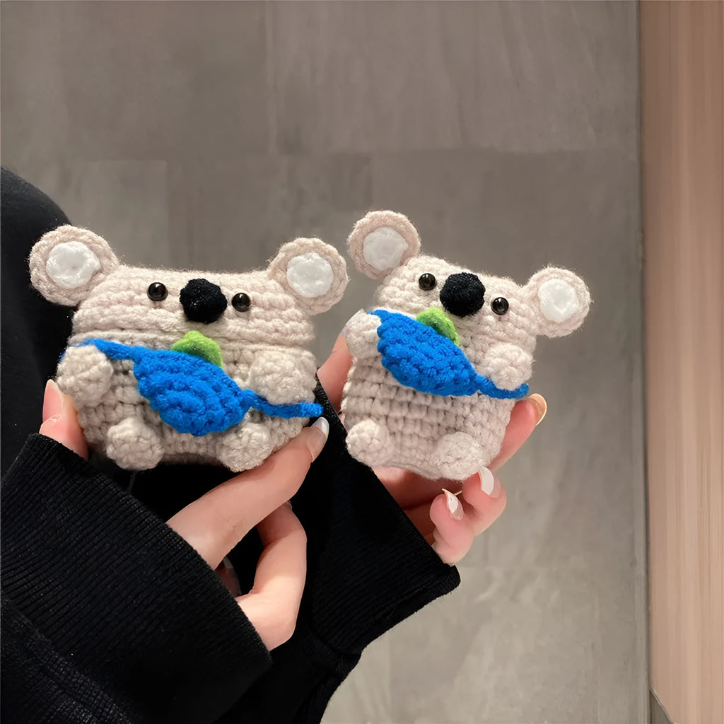Handmade knitted koala bear backpack design cover on an AirPods case.