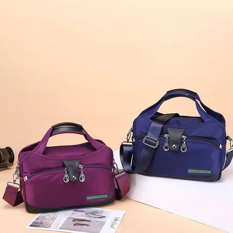 Women's crossbody bag in Oxford cloth with zippered closure and adjustable shoulder strap, 29cm long, available in multiple colours