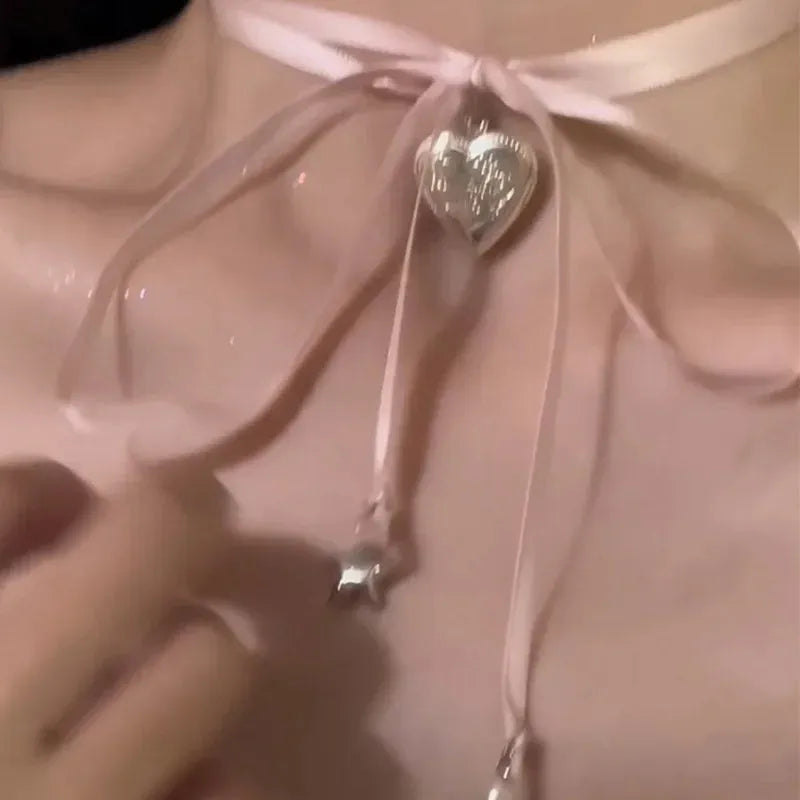 Women's silver tone ribbon love pendant necklace on clavicle length chain