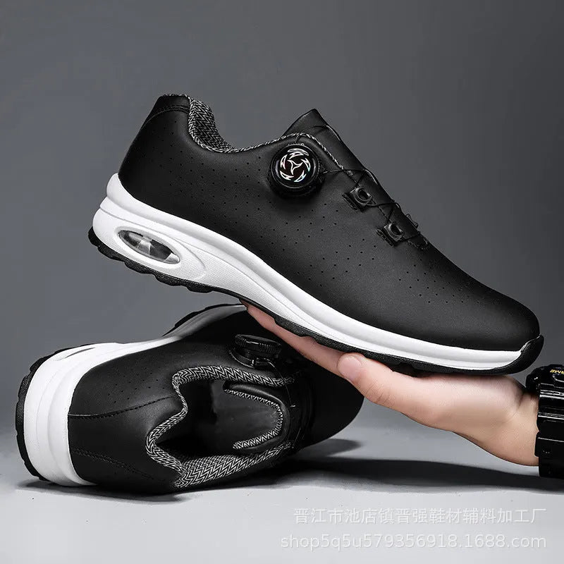 Black and white low-top tennis shoes with mesh upper and cross-shoulder straps on a composite sole.