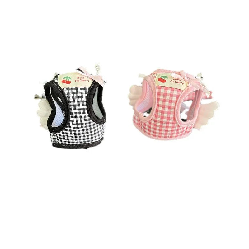 Pink and black cotton chest and back hand holding rope harness for a small dog on a white background.