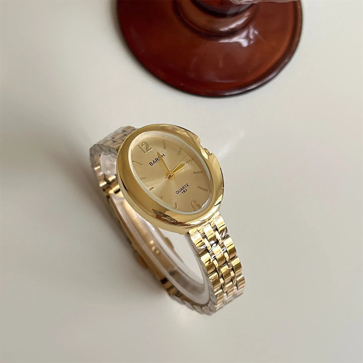 Oval alloy ladies watch with gold strap and choice of white gold or red dial face stainless steel back