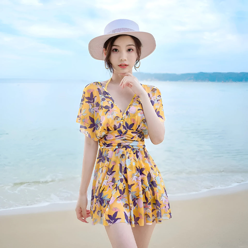 Yellow women's one-piece swimsuit with floral pattern on polyester fabric.