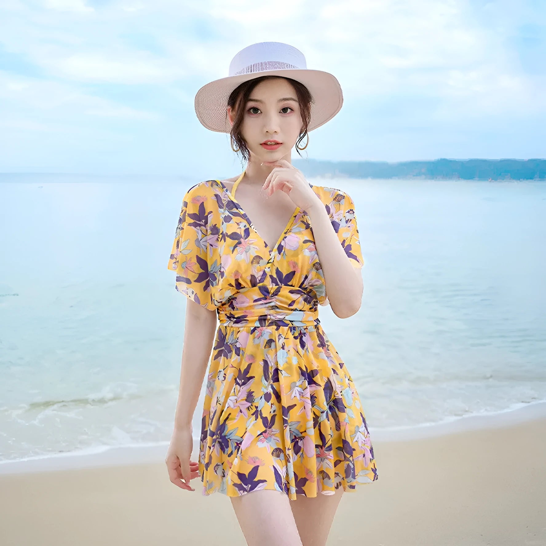 Yellow women's one-piece swimsuit with floral pattern on polyester fabric.