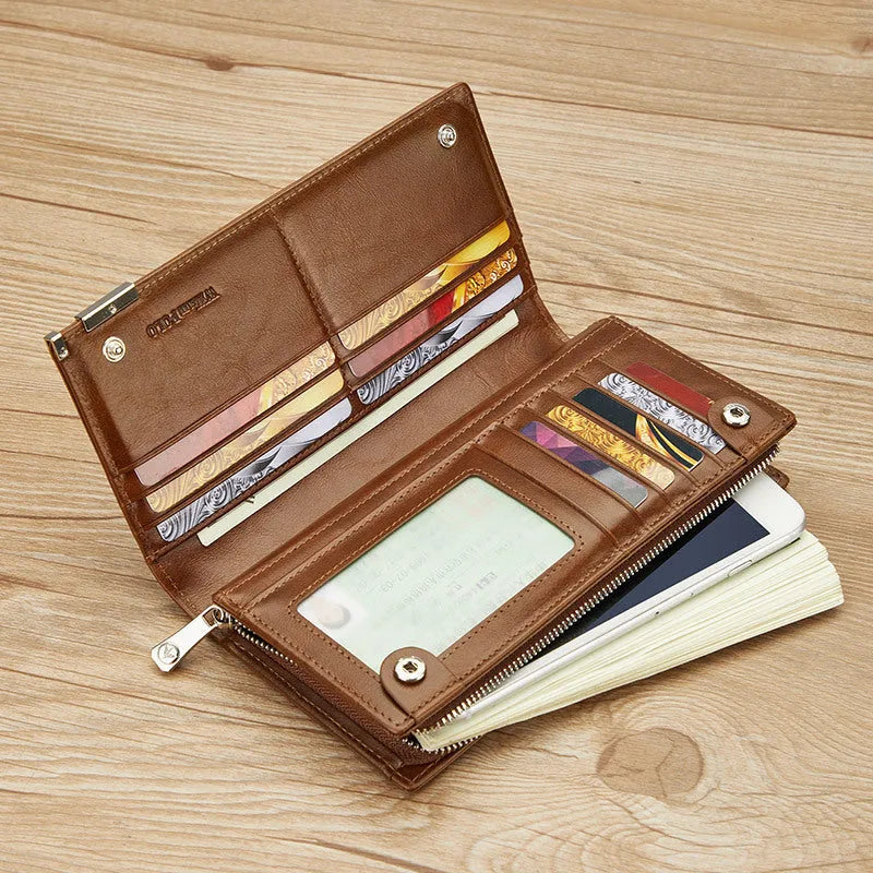 Brown solid colour cowhide leather wallet with contrast stitching laid open showing card slots and cash compartment