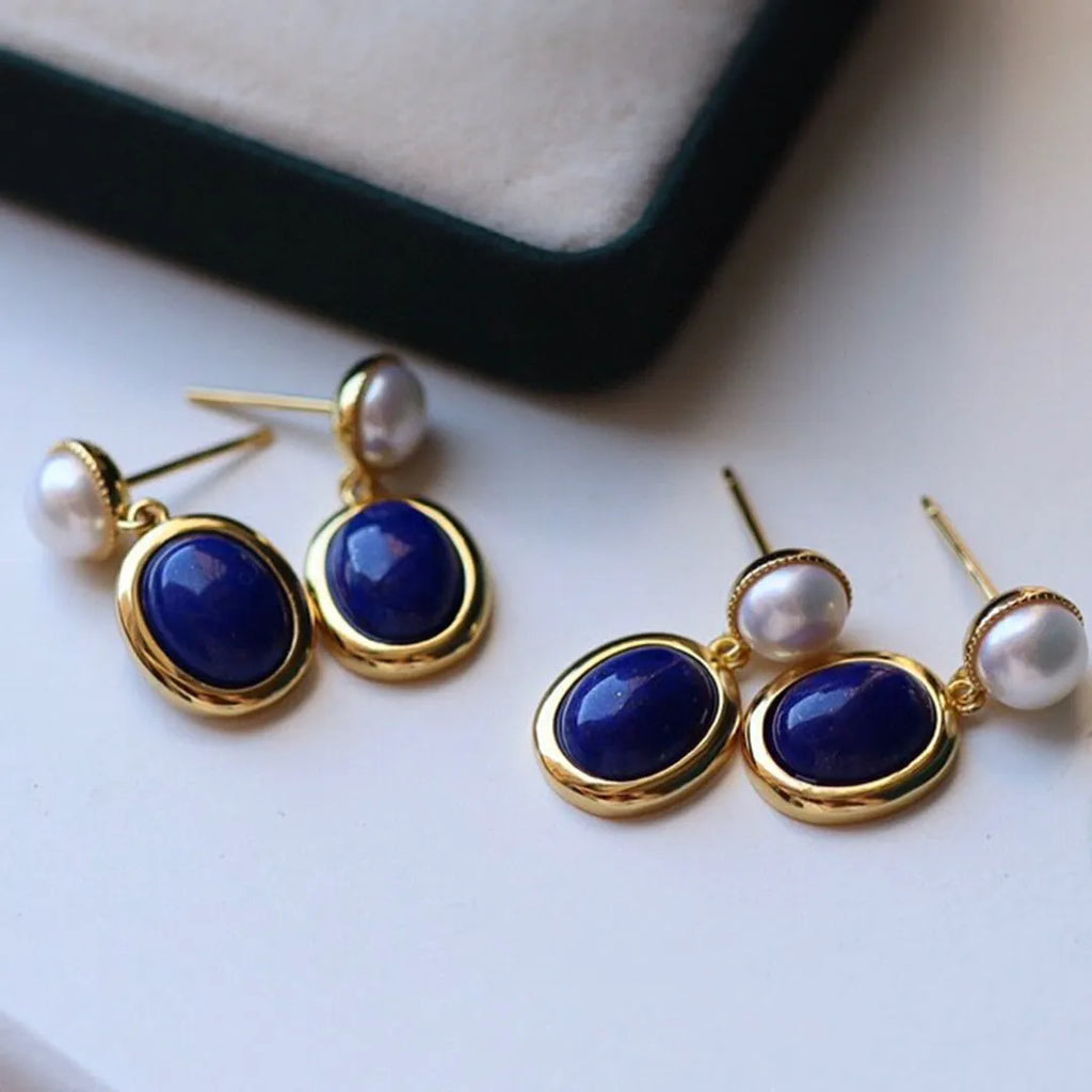 A pair of sterling silver drop earrings with a blue lapis lazuli pearl and auspicious patterns.