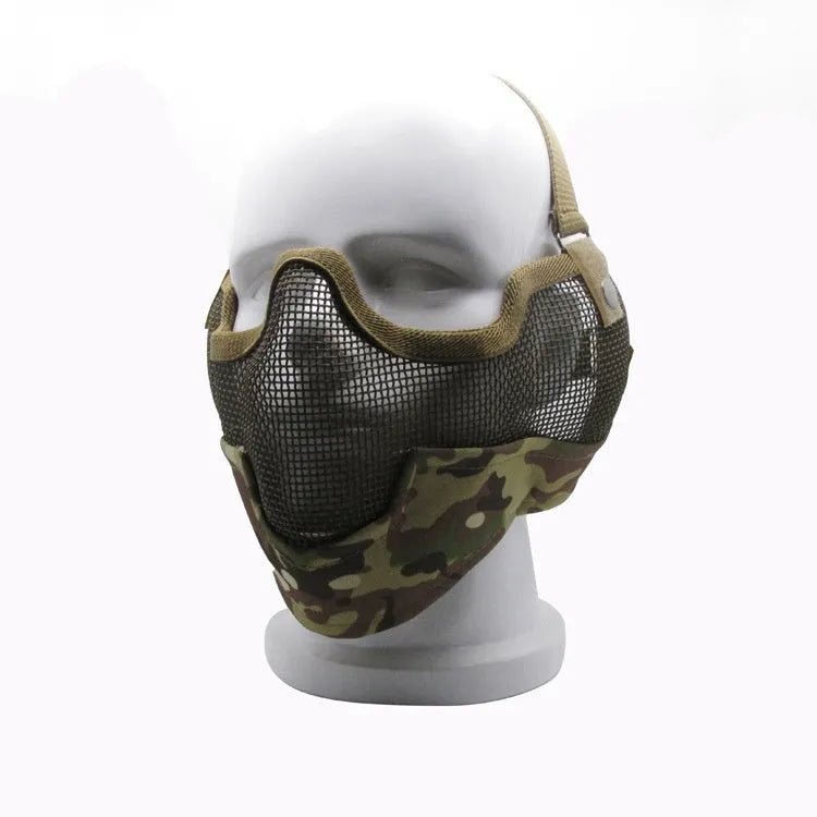 Carbon steel field protective mask with head mount in camouflage pattern, shown with attached mouth muffler.