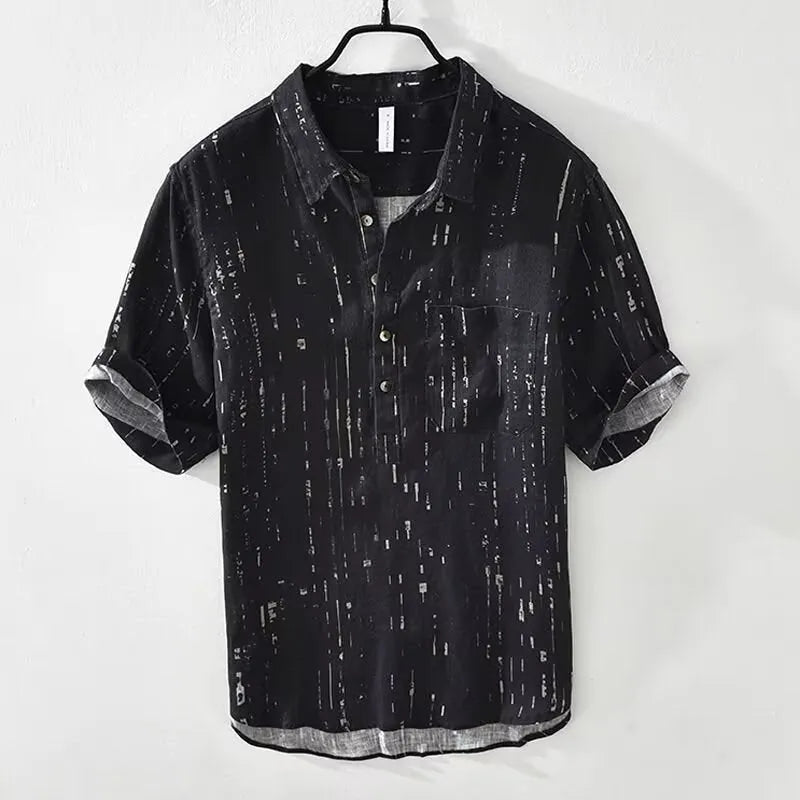Mens loose-fit black polo shirt with a short sleeve and a V-neck lapel collar on a hanger.