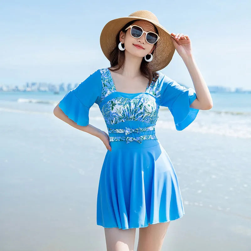 Blue and green women's one-piece swimsuit with seaside print pattern