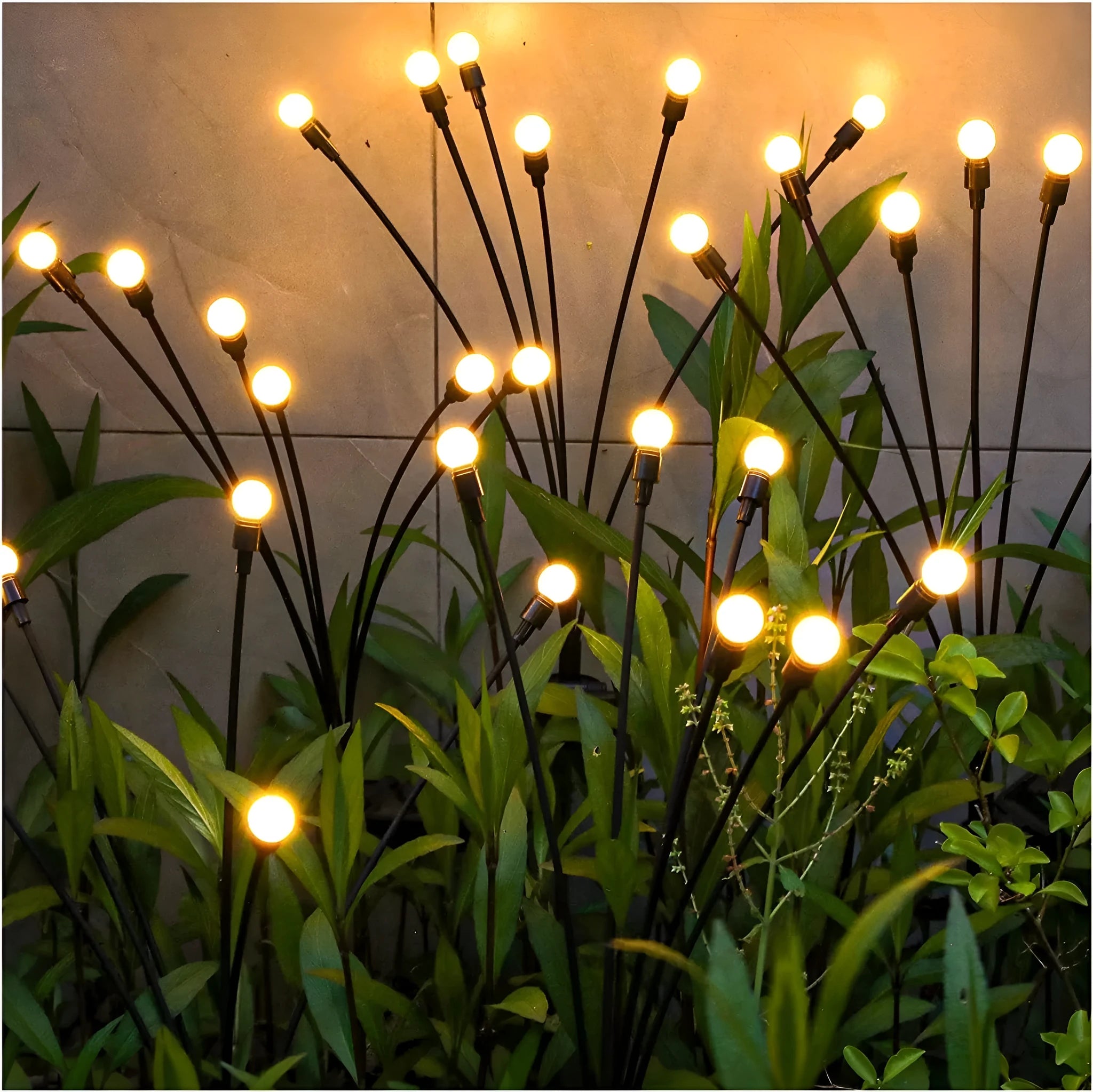 Solar-powered LED garden ground light with stainless steel spike, lit up in a lawn at dusk.