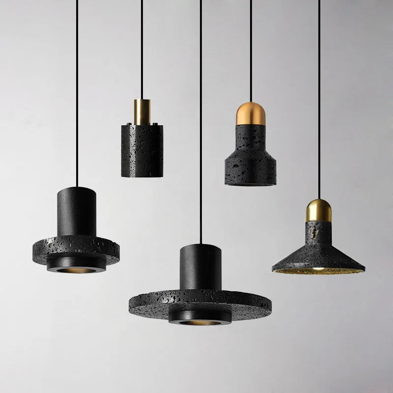 Industrial style black iron chandelier light hanging above a wooden bar table.