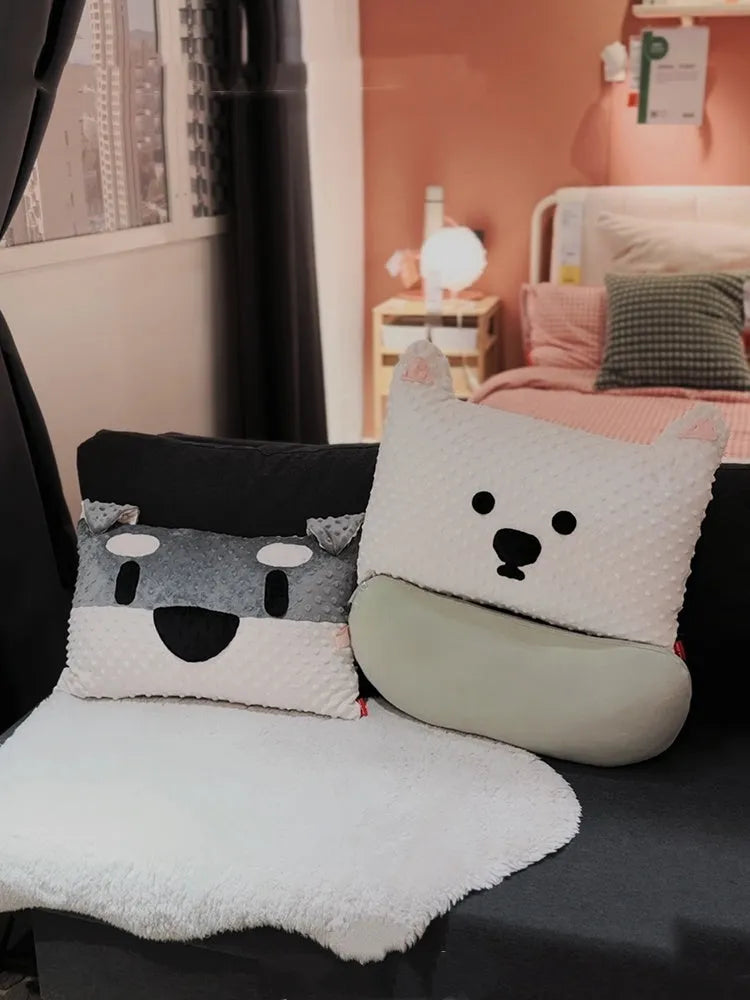 Grey and white West Highland puppy pillow dog cushion on a sofa.